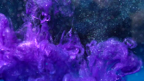 Metallic-purple-luminescent-ink-drop-flowing-in-liquid-water-with-particles-and-bokeh-lights-on-a-dark-black-sci-fi-background-SLOW-MOTION