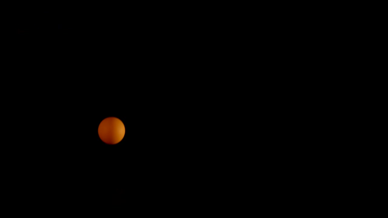 Orange ball bouncing in a dark space