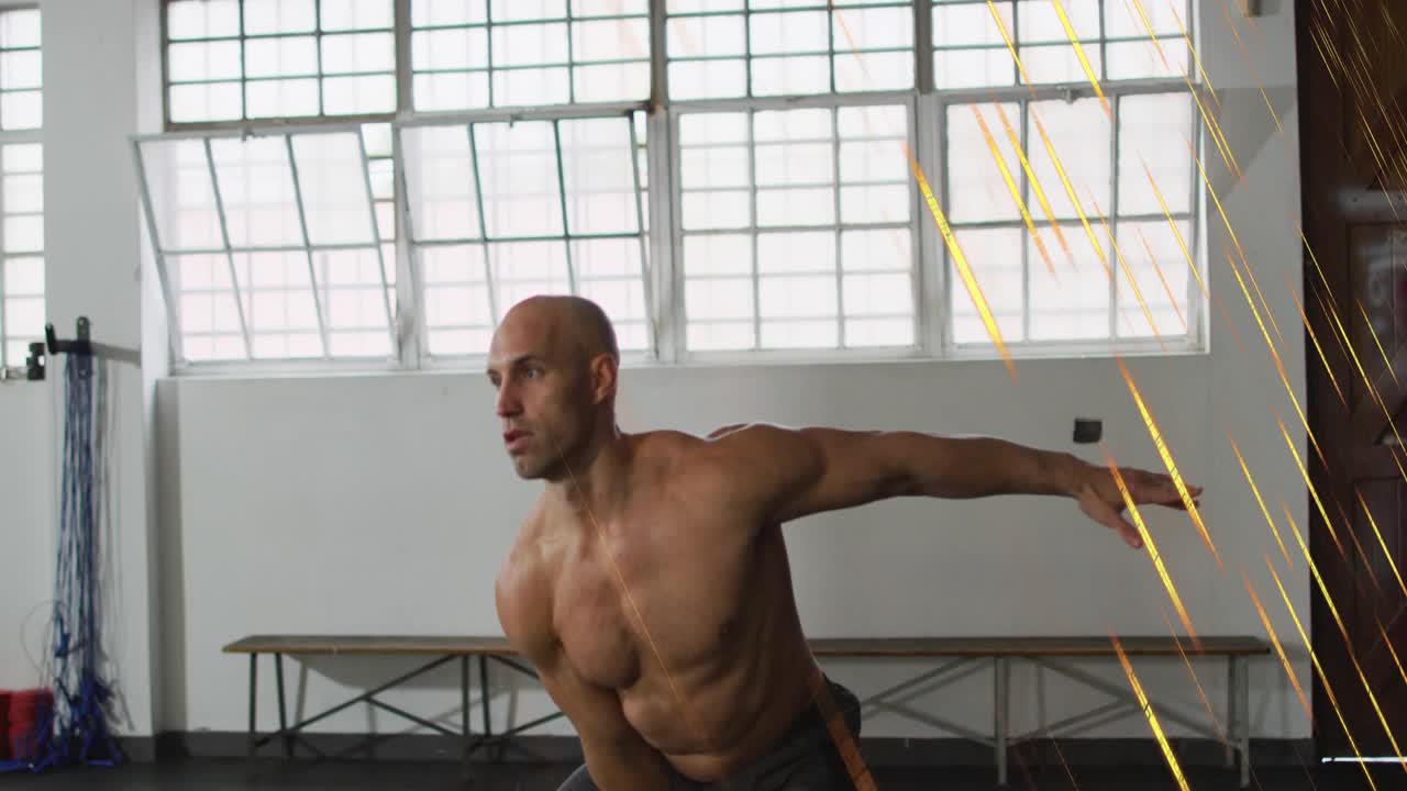 Shirtless man performing kettlebell swing for core in gym, hip hinge initiating motion streaks