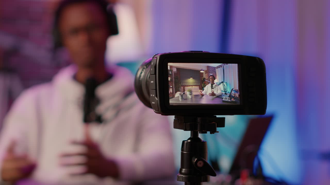 Selective focus on digital video camera screen recording african american content creator streaming live internet show