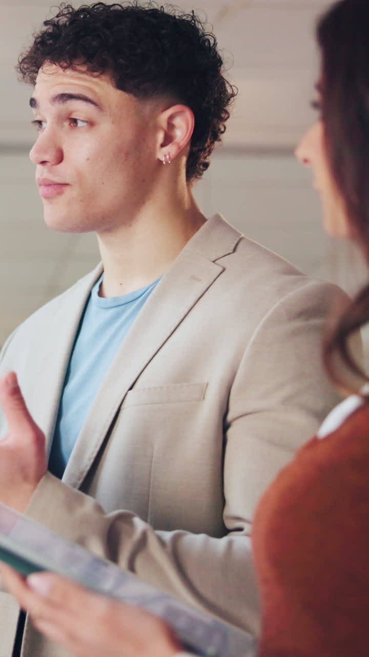 Young Man Talking and Gesturing in a Professional Conversation