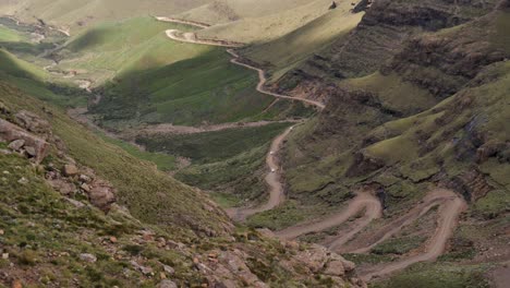 Tourist-trucks-finish-steep-switchback-segment-of-Sani-Pass,-S-Africa