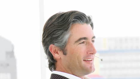 close up of businessman with a headset on in office