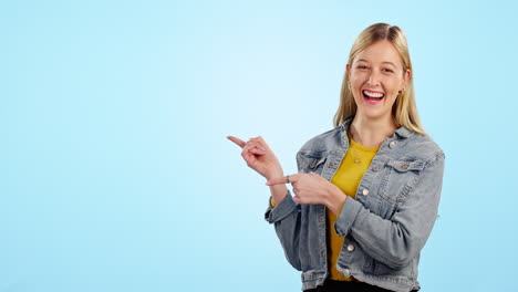 Woman,-point-and-happy-in-studio