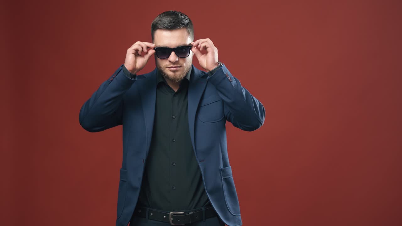 Handsome young businessman. Positive businessman wearing glasses in studio