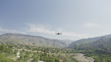 drone flying over a mountain valley with a village