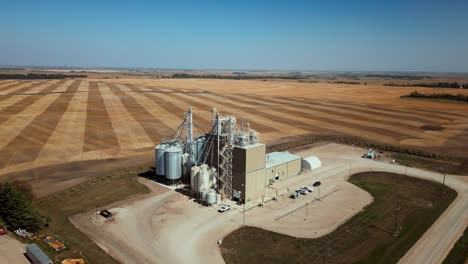 4k drone descending shot of a farm grain elevator business in the midwest