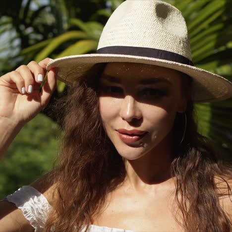 Stylish-woman-adjusting-summer-hat