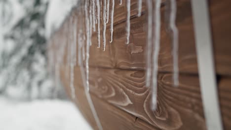 Close-up-of-winter-stalactite-at-the-wooden-barrel