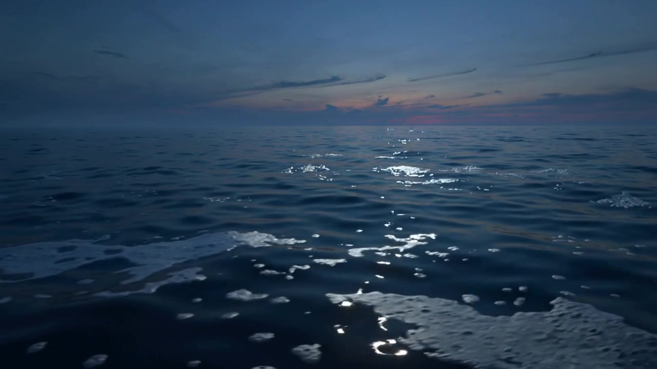 Breeze stirring open sea surface shifting foam patches at sea, reflecting warm glow