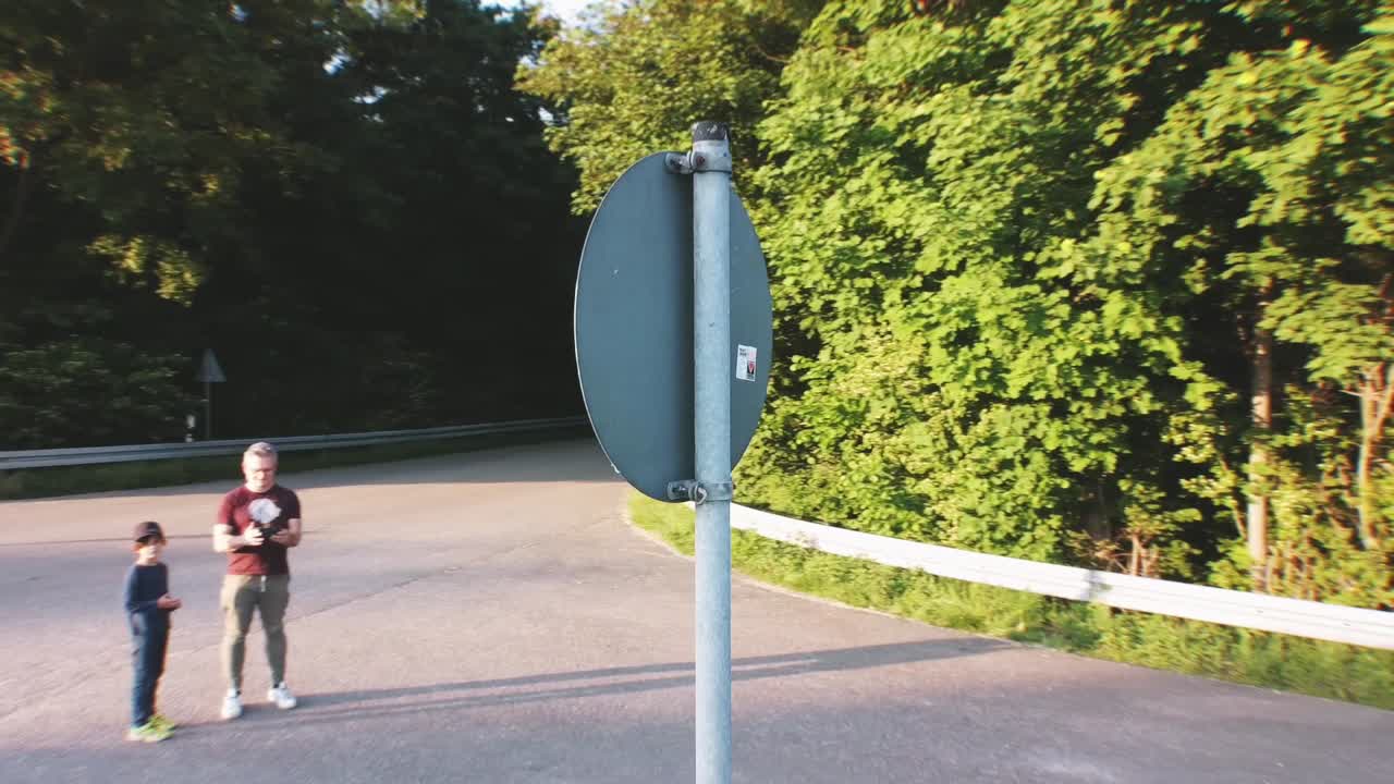 Aerial footage of a european roadsign being filmed while circling around the object on a sunny day
