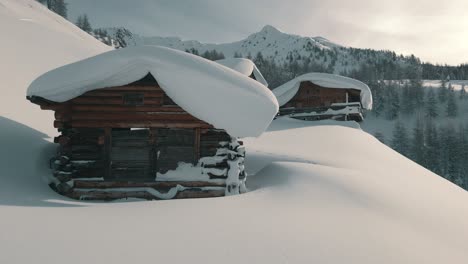 idyllic natural landscape in the alps with snowy mountain huts