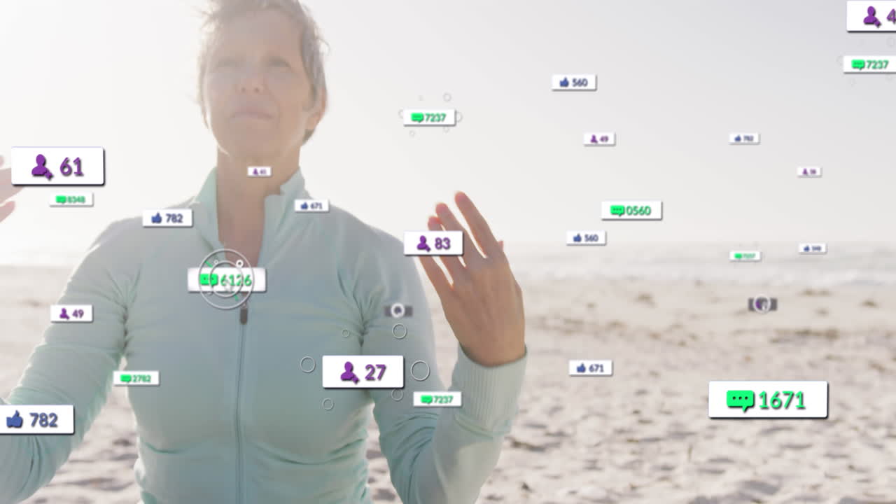 Animation of social media notifications, over happy woman doing yoga on beach