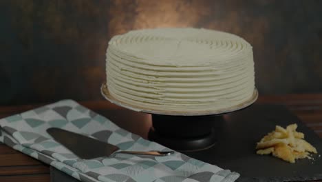 beauty shot of a delicious frosted cake rotating on a stand