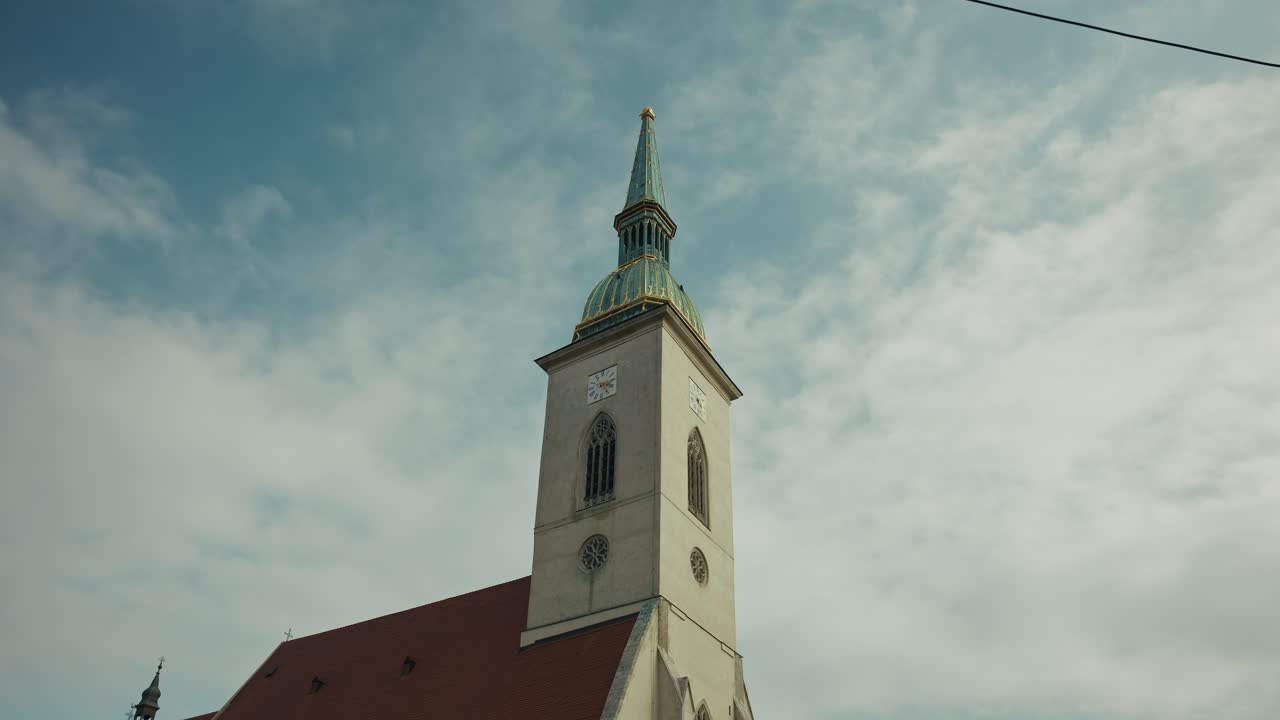 St. Martin’s Cathedral tower rises under a blue sky in Bratislava