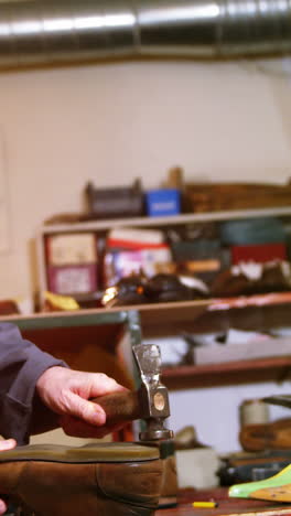 shoemaker hammering on a shoe