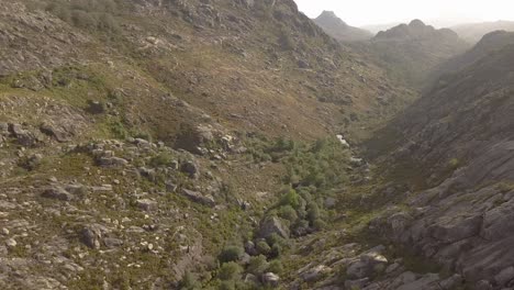 Village-and-Mountains-of-Castro-Laboreiro,-Portugal-Elderly-castle-ruins,-medieval-age,-river-valley,-dry-river