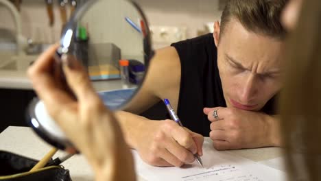 person concentrating and writing