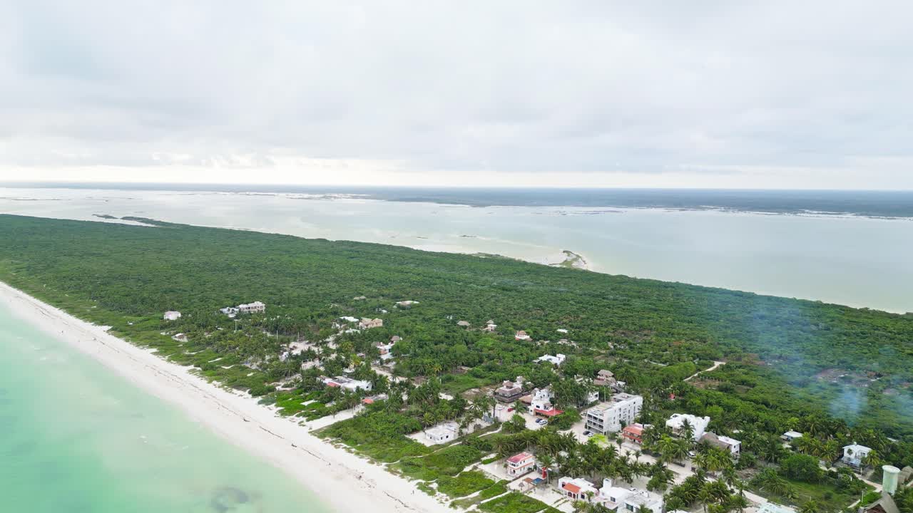 A beautiful beach in cuyo, yucatán, surrounded by lush greenery, aerial view
