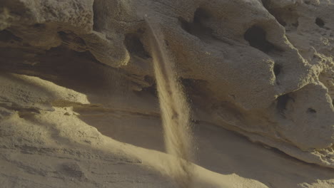 sand falling from a cliff face