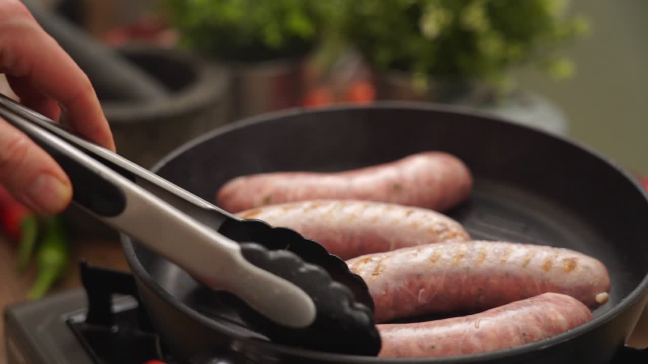 Crop person turning homemade sausages frying in pan
