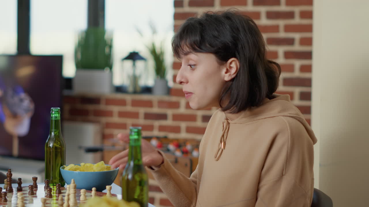 Focused woman playing strategic board games with friends