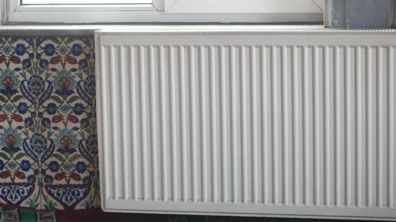 White Radiator and Decorative Tiles in a Room