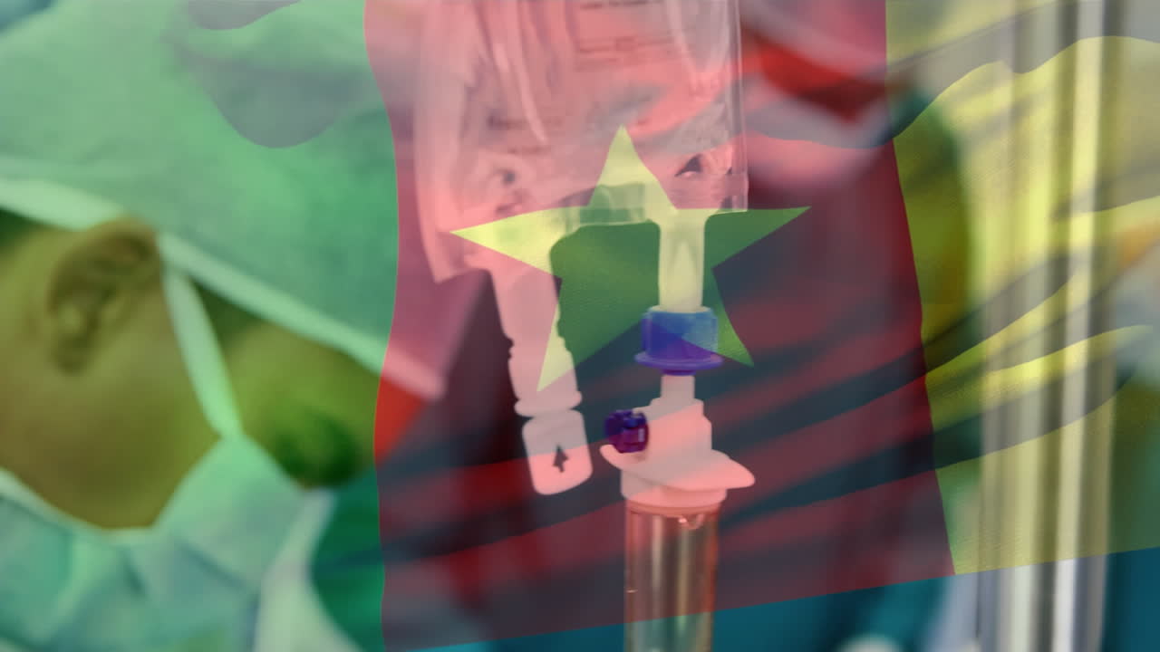 Animation of flag of camroon waving over surgeons in operating theatre