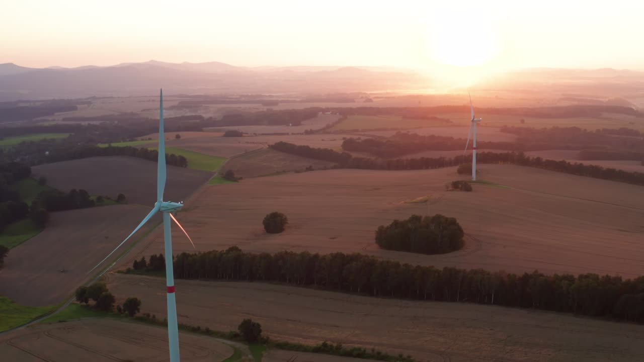 Powerful wind machines built at electric station at sunset
