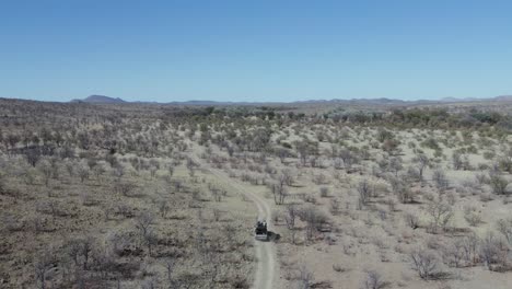 Off-road-vehicle-driving-through-Namibia-territory-during-safari,-Africa