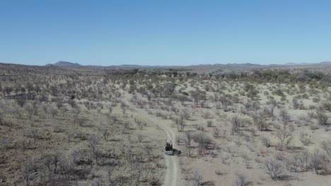 off road vehicle driving through namibia territory during safari, africa