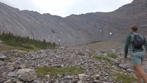 hiker walking up mountain followed tilt rockies kananaskis alberta canada