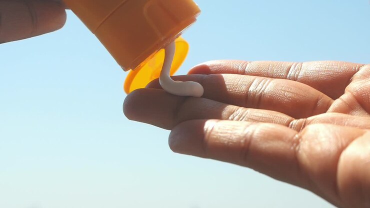Applying Sunscreen Lotion on Hand