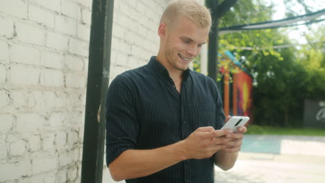 Young man using a mobile phone outdoors