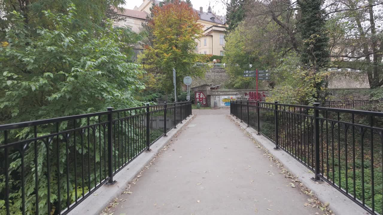 Bridge over the river in Olomouc. Walk through the historic town in Bohemia. Leafy park