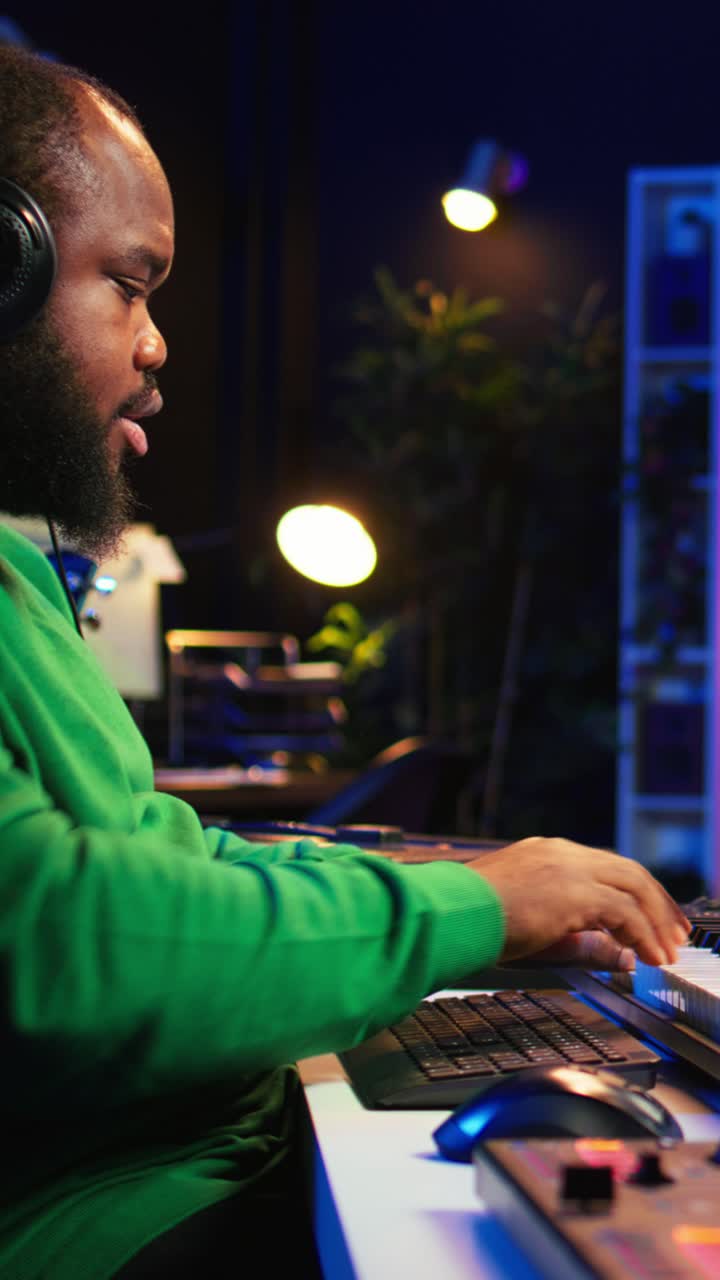 African American Music Producer Working in Home Studio