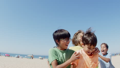 Slow-motion-of-happy-teen-sportsmen-celebrating-winning-on-beach