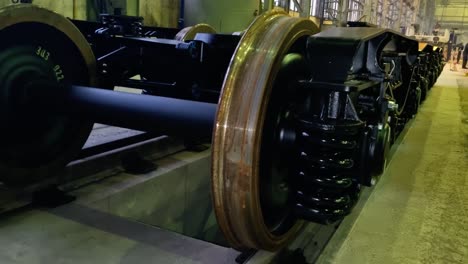 Building large metal driving wheels for train locomotive in factory, pan