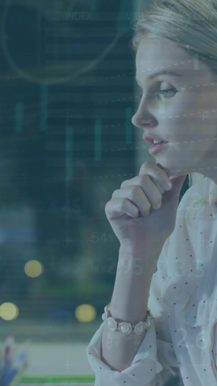 Animation of graphs, loading circles, trading board, thoughtful caucasian woman writing on notepad