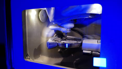 work of the dental milling machine. professional cnc dental milling machine carving out shape of artificial teeth in the dental lab