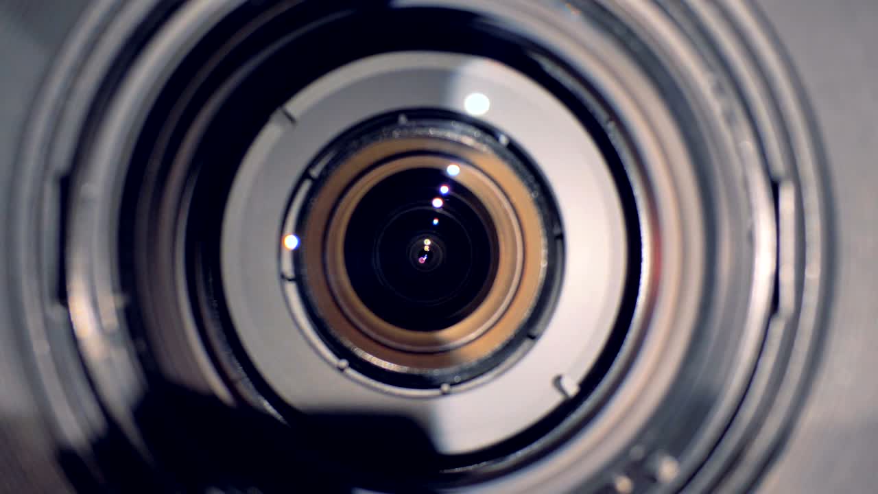 Camera lens is turning and ends up being directed straight at the viewer