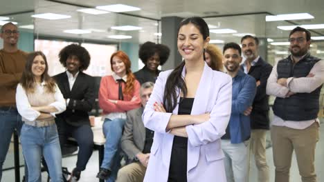 smiling female leader standing with crossed arms