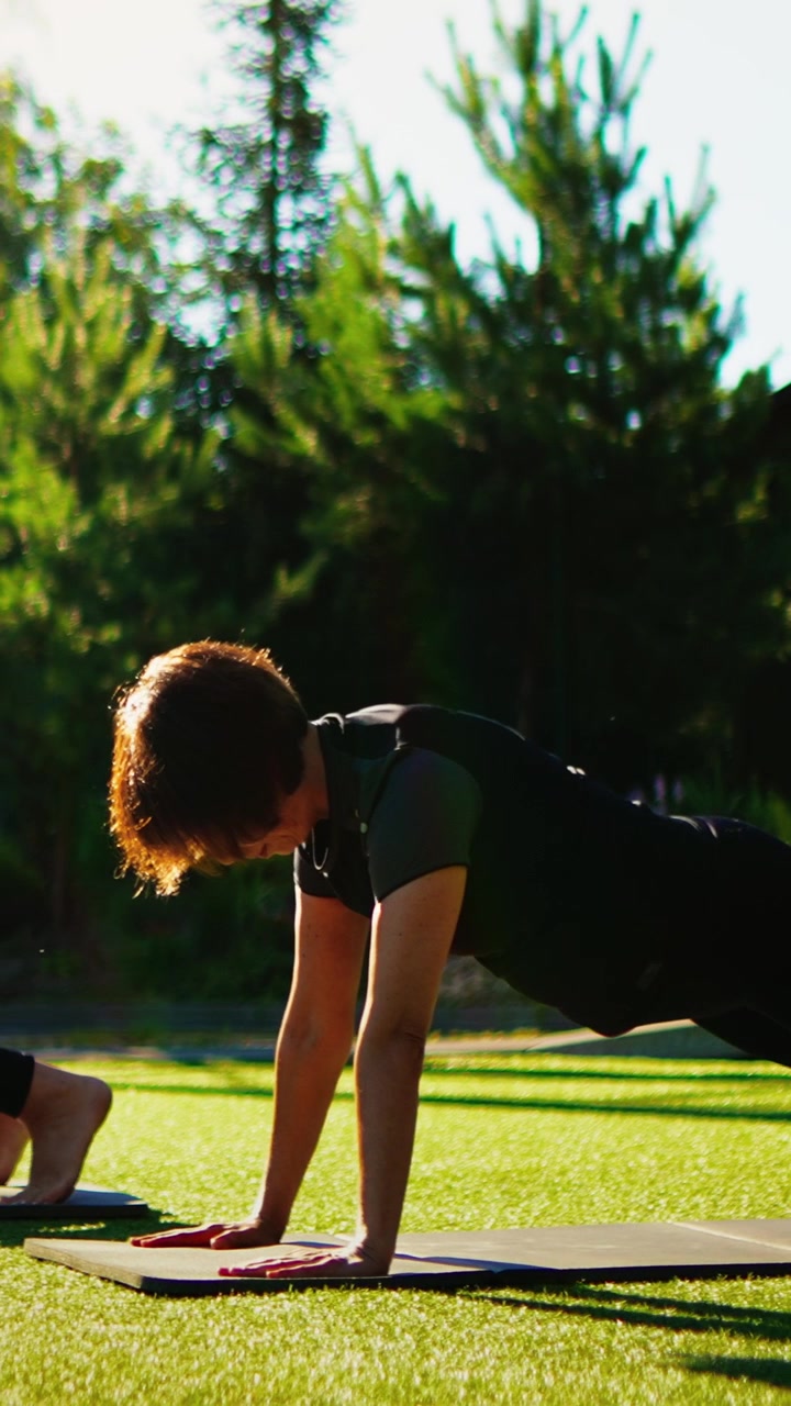 Woman Holding Plank Position on Yoga Mat Outdoors