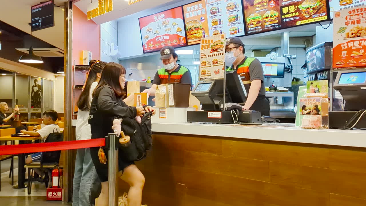 Motion of people ordering food at check out counter inside Burger Kings in Taipei Taiwan with 4k resolution