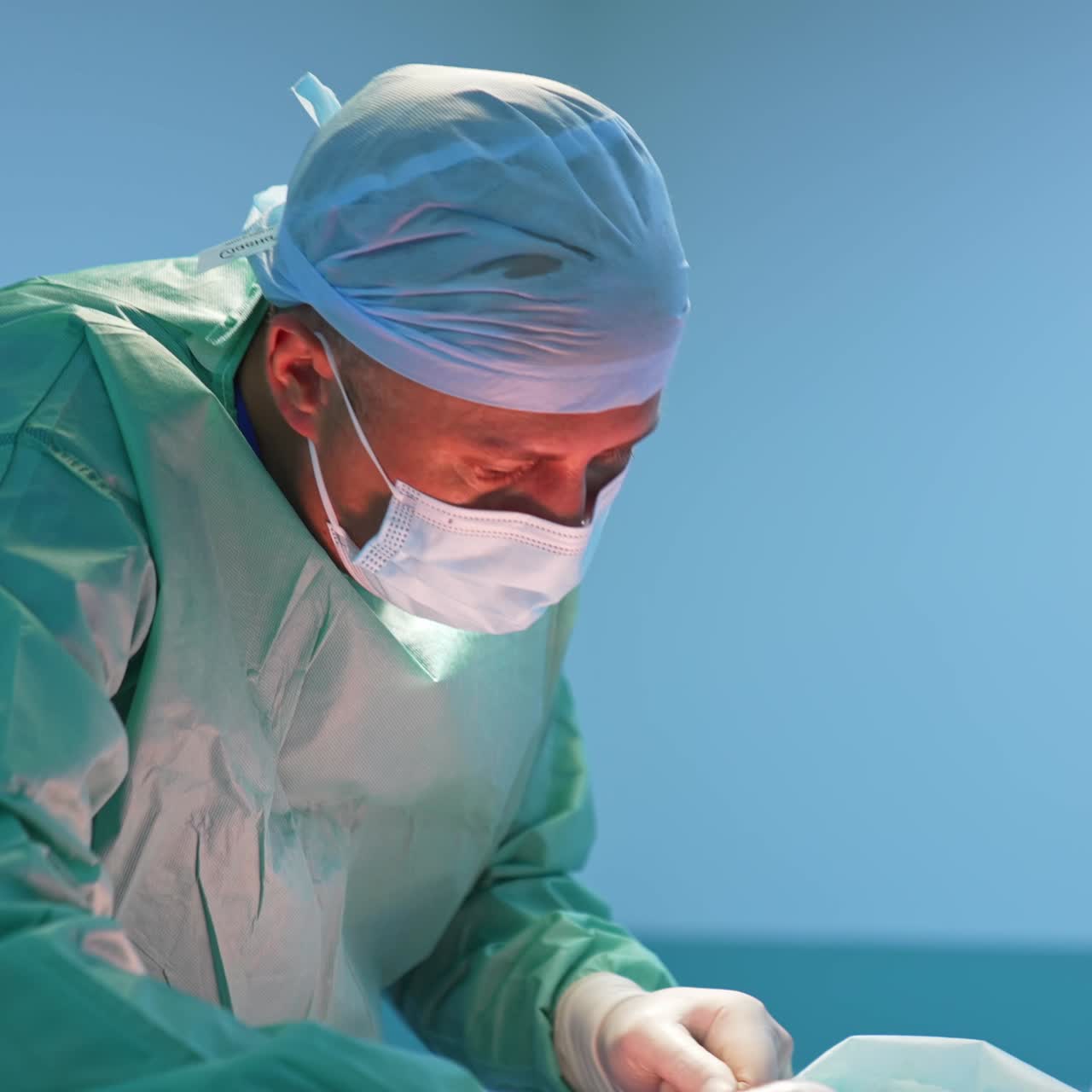 Surgeon Operating In The Hospital. Surgeon operating the patient in operation room in hospital