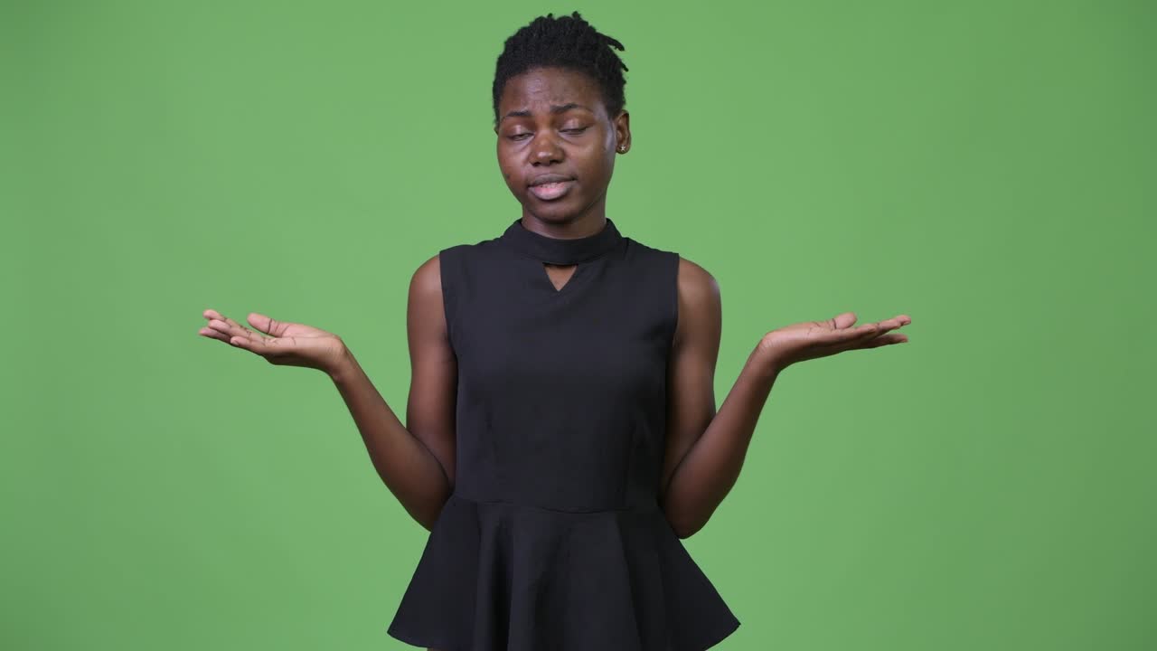 Young beautiful African businesswoman shrugging shoulders