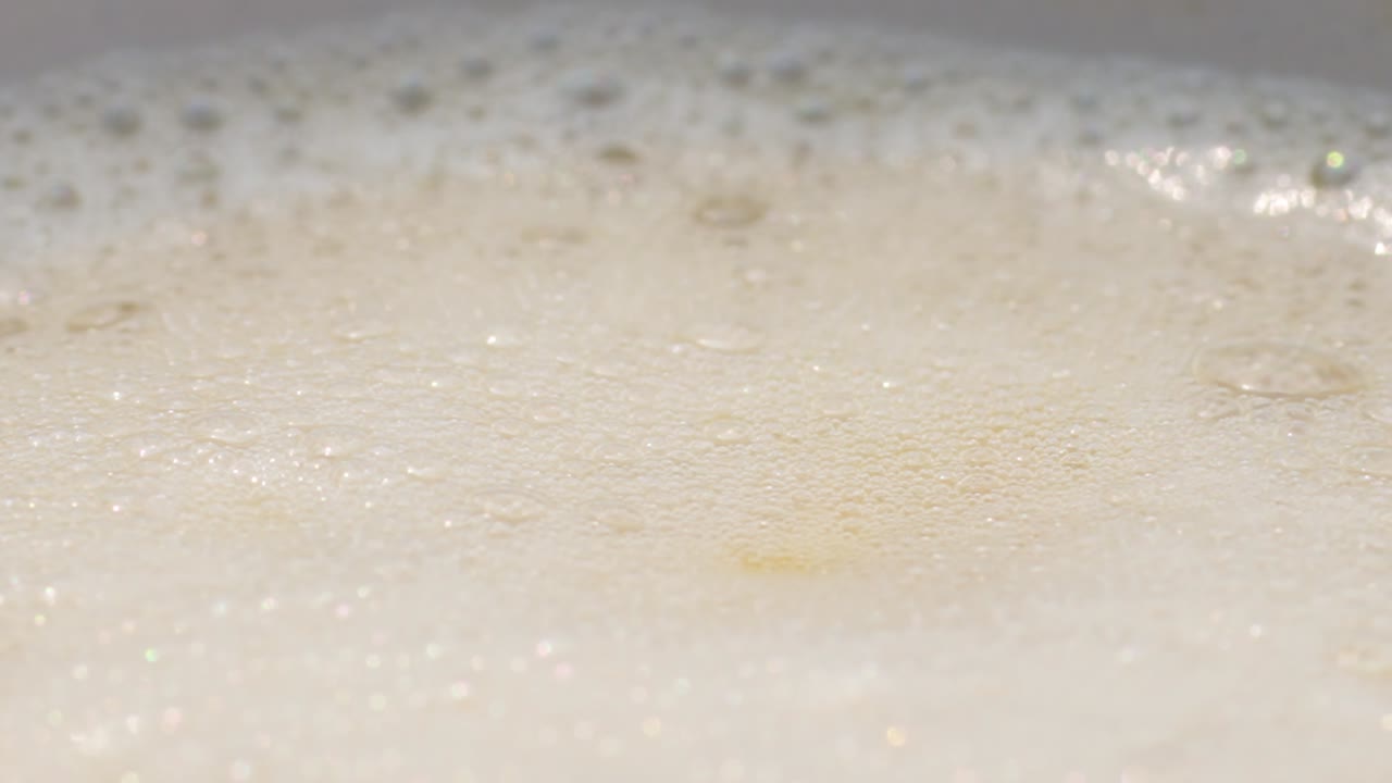 Slowmotion of frothy coffee surface, creating calming ambiance