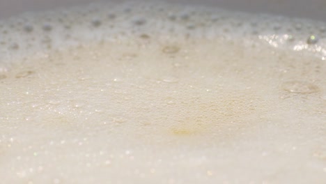 slowmotion of frothy coffee surface, creating calming ambiance