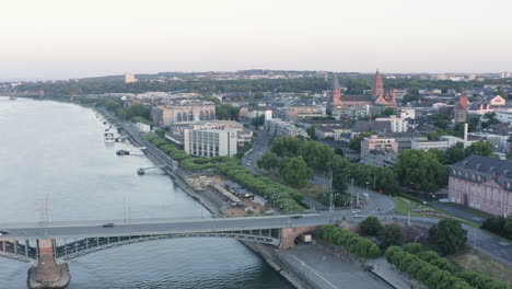 aerial approach drone view of mainz rhine river, castle, dom, theodor heuss bridge and cityscape at sunset germany 4k