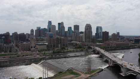 wide aerial panning shot of downtown minneapolis, minnesota along the mississippi river